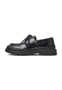 Black leather boat shoes with a rounded toe, lace-up design, stitched accents, and a chunky rubber sole featuring a textured grip pattern.