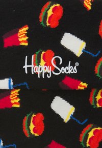 Calze nere con motivi di cibo colorati, tra cui hamburger, patatine e bevande, con il logo "Happy Socks" in bella vista.
