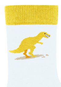 Weißer Socke mit einem gelben gerippten Bund, ausgestattet mit einem gestickten gelben Dinosaurier im Profil und beigen Details im Fußbereich.