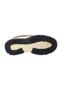 Gummisohle mit einem schwarzen strukturierten Muster und beigen Akzenten, versehen mit erhabenen Profilen für Grip und Unterstützung. Mit Markenname gekennzeichnet.