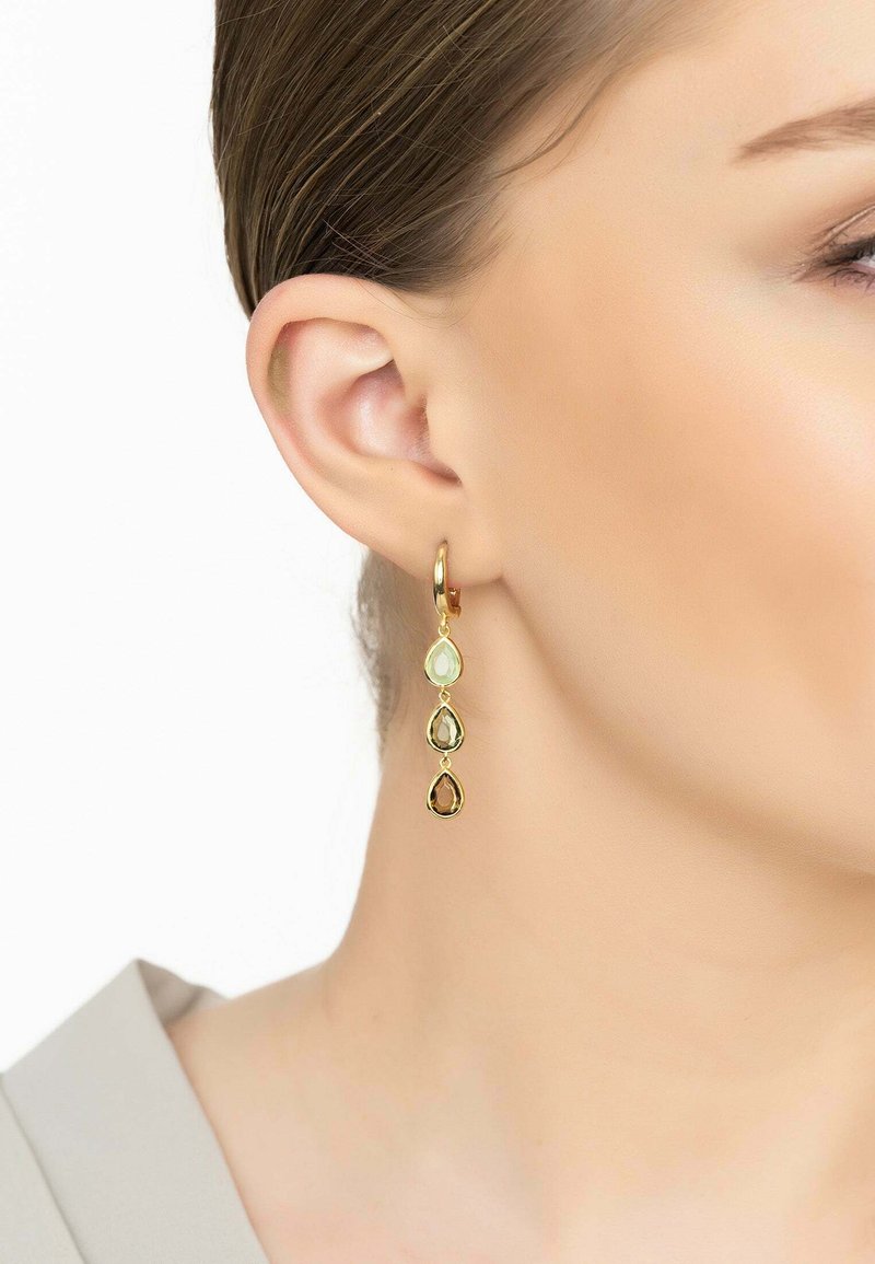 Gold hoop earrings with three dangling, teardrop-shaped stones: pale green, amber, and brown. Sleek design with a shiny finish.