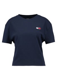 Cotton navy blue t-shirt with a crew neckline and short sleeves. Features a small logo patch in red, white, and blue on the left chest.
