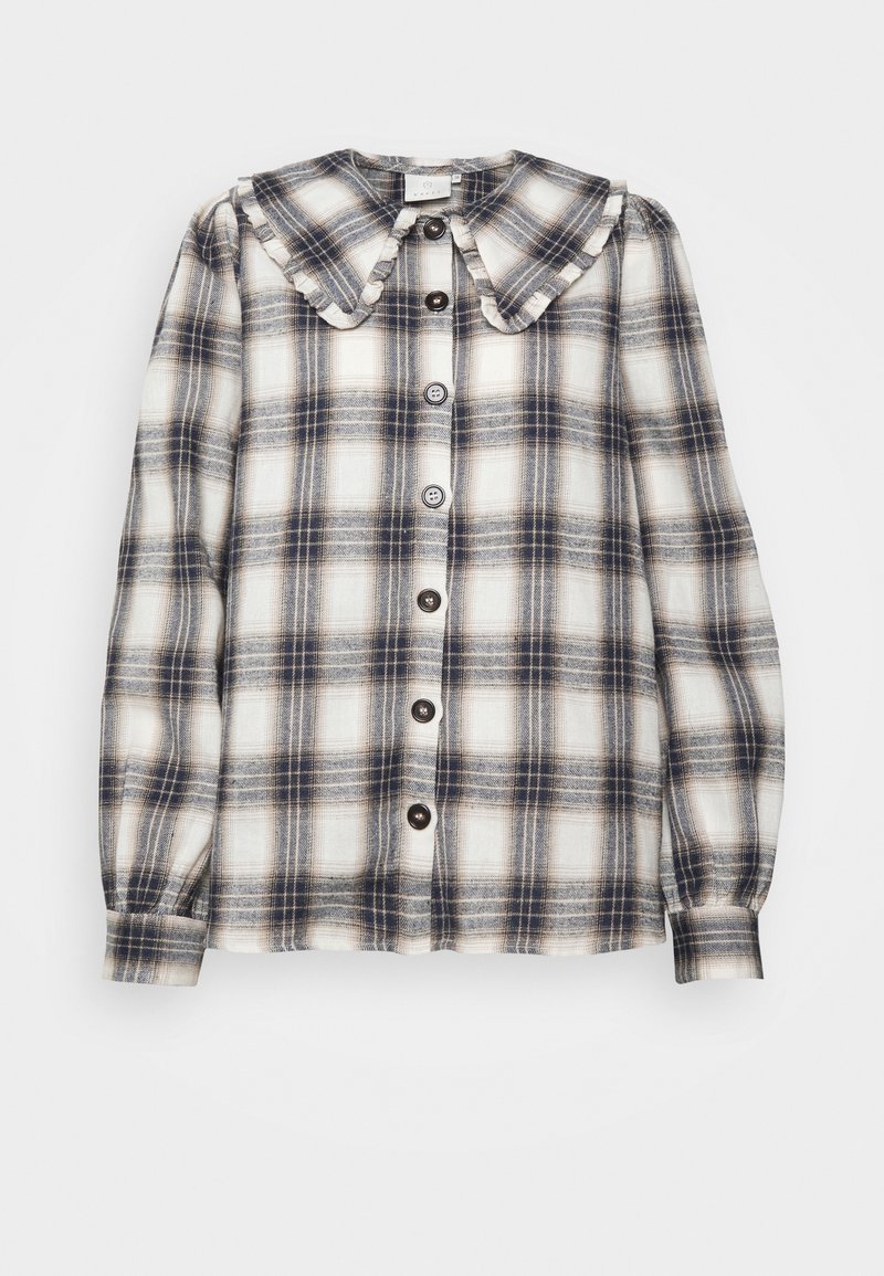 Chemise à manches longues à carreaux avec un large col volanté et des boutons sur le devant dans des tons de blanc, noir et gris.