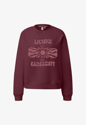 Burgundowa bluza z ribbowymi mankietami i dołem. Posiada dużą, jasnoróżową grafikę z napisem "ŻYJĄC CHWILĄ" oraz wzorem słońca.