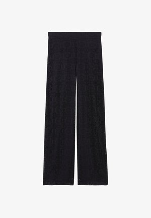 Schwarze weite Hosen aus strukturiertem Spitze mit einem kreisförmigen Muster und einem elastischen Bund. Das Design betont eine fließende Silhouette.