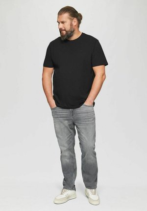 Black cotton t-shirt, gray denim jeans, and white sneakers. Casual fit, plain design, and subtle accent of the brand logo on the shirt.