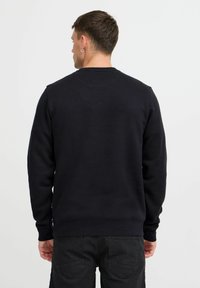 Zwarte sweatshirt van een katoenmix, met een klassieke ronde hals, ribgebreide manchetten en tailleband. Glad textuur met een eenvoudige ontwerp.
