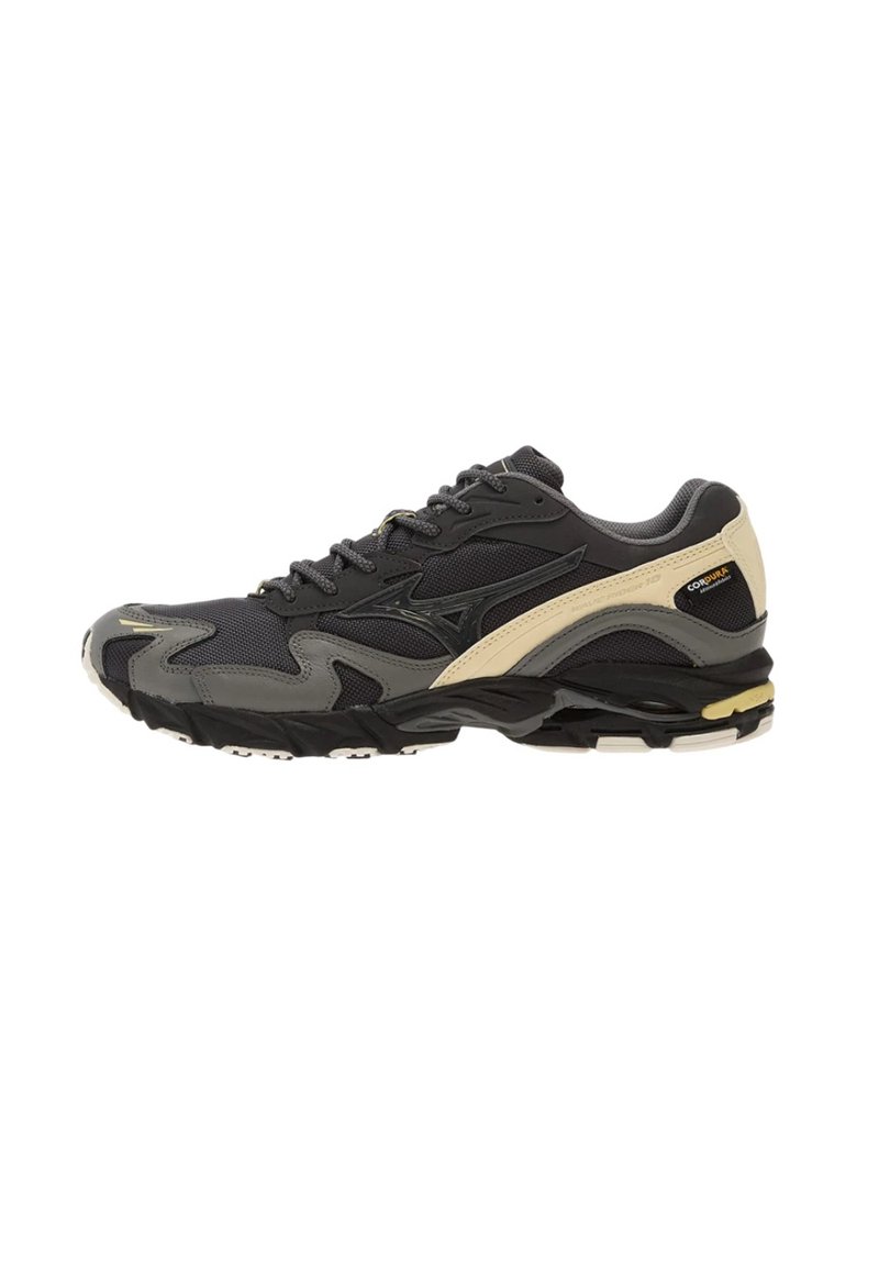 Scarpa sportiva nera e grigia con dettagli beige, tomaia in rete e materiali sintetici, design con lacci e suola imbottita per supporto e comfort.
