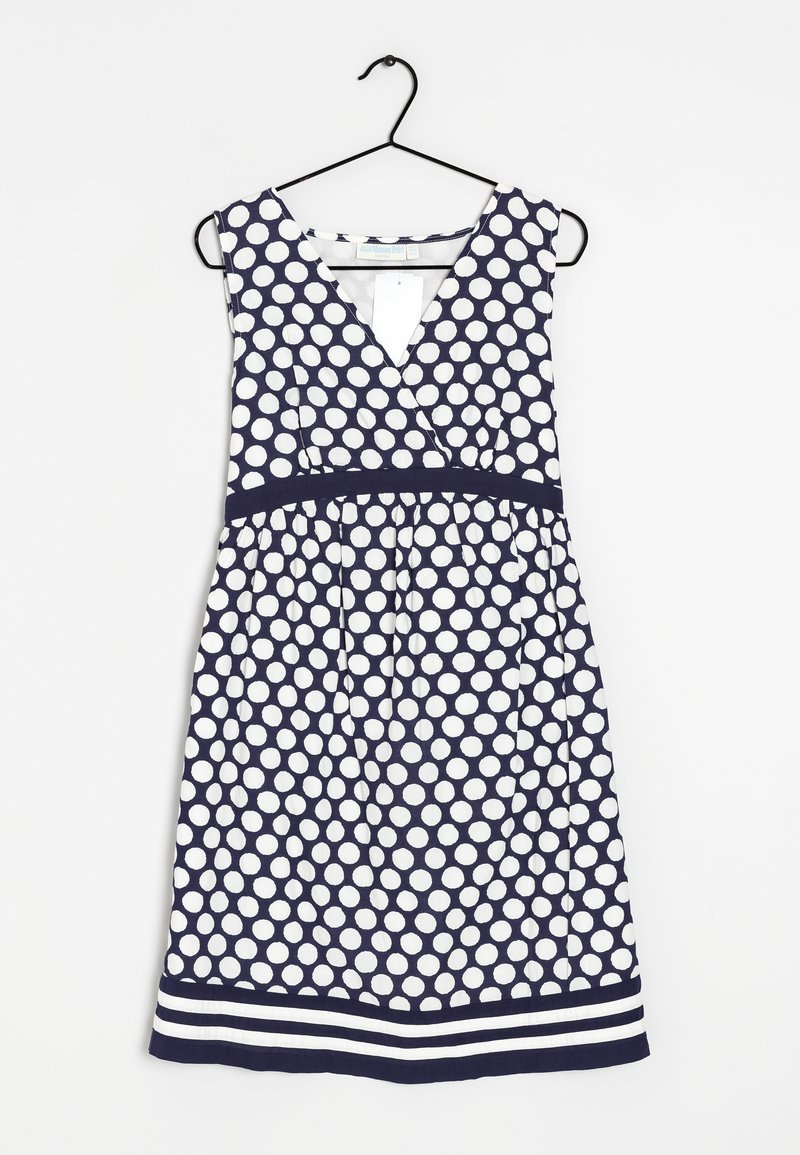 Vestido de lunares en azul marino y blanco con escote en V y forma en A. Cuenta con una cintura ajustada y un detalle de dobladillo a rayas. Fabricado con tela ligera.