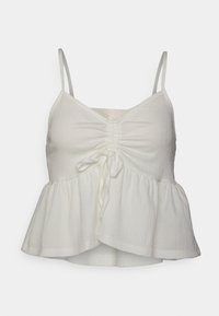 Vit peplumtop med justerbara spaghetti-remmar, med framsamling och ett lätt, texturerat tyg.
