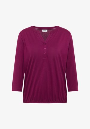 Fialová halenka s dlouhým rukávem, třemi knoflíky na výstřihu do V a elastickým lemem, s cedulkou "Cecil" na límci.