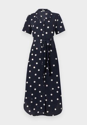 Abito blu navy con maniche corte, pois bianchi, apertura con bottoni e cintura annodata in vita, realizzato in un tessuto liscio. Design lungo e fluente.