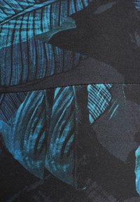 Floral-patterned fabric with large blue leaves on a black background. Smooth texture, fitted design, and vertical lines create a structured look.
