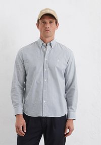 Striped button-up shirt in light blue and white, cotton blend fabric, fitted design, with a classic collar and long sleeves.
