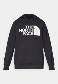 Zwarte hoodie van zachte stof met een groot wit logo aan de voorkant. Het heeft een capuchon met trekkoord en een ruime kangoeroezak.