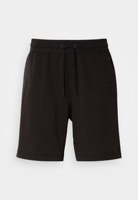 Pantaloni corti neri in cotone con vita elastica, dettaglio con stringa, tasche laterali e vestibilità comoda. Texture liscia e design lungo fino al ginocchio.