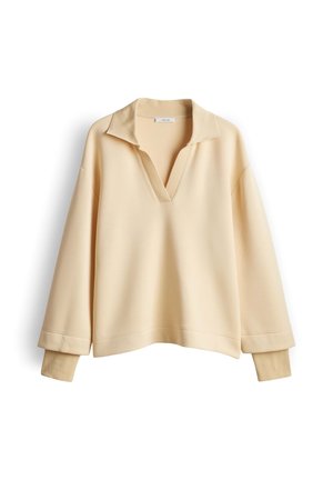 Maglione beige a manica lunga con collo e polsini a coste, con scollo a V profondo e vestibilità rilassata.