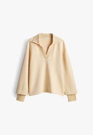 Maglione beige a manica lunga con collo e polsini a coste, con scollo a V profondo e vestibilità rilassata.