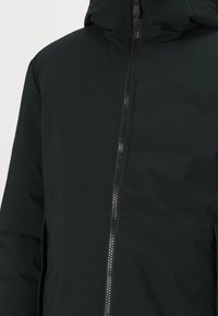 Black insulated jacket with a smooth texture, featuring a front zipper closure and a hood. The design is minimalistic with no visible patterns.
