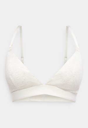 Lys beige trekantet brystholder med justerbare tynde stropper og bred elastisk underbånd, vist mod en ensfarvet baggrund.