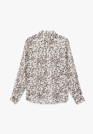 Lichte blouse met lange mouwen in een beige stof met een bruine stippenpatroon. Voorzien van een klassieke kraag en een knoopsluiting aan de voorkant.