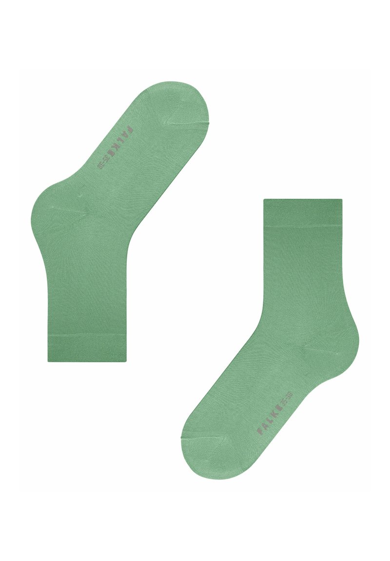 Chaussettes en coton vert avec une texture lisse. Bords côtelés et renfort au talon et aux orteils. Nom de la marque "FALKE" imprimé en rose pâle.
