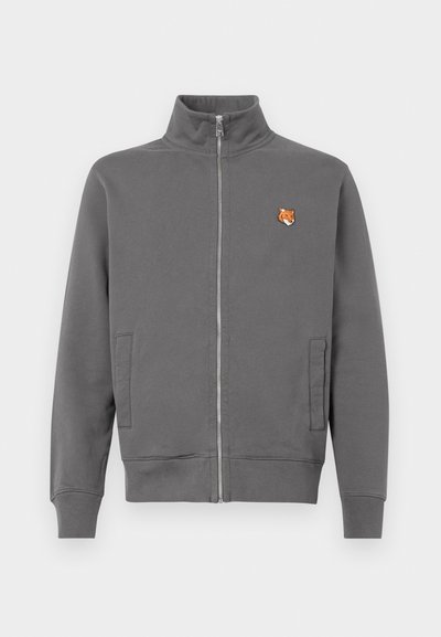 Gray zip-up sweatshirt in soft fabric, featuring side pockets and a small orange fox embroidery on the left chest. Standard collar design.