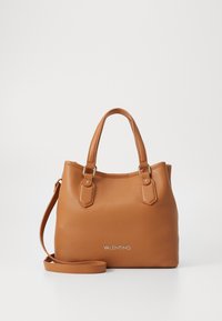 Brown pebbled leather handbag with two top handles, detachable shoulder strap, and gold-tone hardware. Features brand name embossed on front.