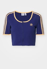Mörkblå kortad Adidas-tröja med dragkedja fram, korta ärmar, gula kanter, tre gula axelränder och Adidas-logotyp på vänster bröst.