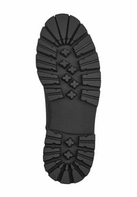 Semelle en caoutchouc noir avec un motif de grip texturé, comportant des crêtes surélevées et des accents circulaires. Taille 37 embossée sur le côté.