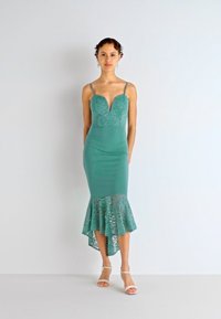 Rochie midi teal cu un bust din dantelă și o margine din dantelă cu volane. Dispune de bretele subțiri și un decolteu în V, creând o siluetă ajustată.