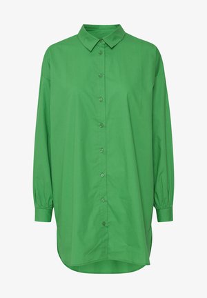 Vihreä napitettava paita, jossa on kaulus, pitkät hihat ja väljä leikkaus. Silkkinen kangas, jossa on tasainen väri ja kaareva helma.