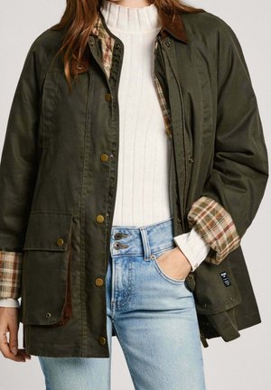 Khaki groene jas met een geruit voering, drukknopen en een corduroy kraag. Gecombineerd met lichtblauwe high-waisted jeans.