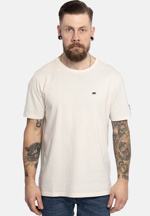 Helles beiges T-Shirt aus Baumwolle mit rundem Ausschnitt, kurzen Ärmeln und einem kleinen schwarzen Bären-Logo auf der Brust.