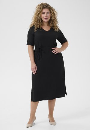 Black dress made of soft fabric with a V-neck, short sleeves, and a drawstring waist. Features a straight cut and side slits.