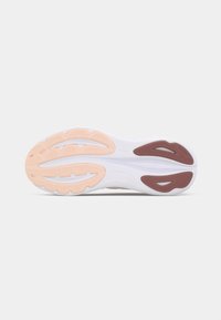 Shoe outsole in white with light peach and maroon accents, featuring textured tread patterns and reinforced areas for traction and support.