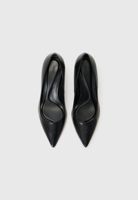 Scarpe con tacco alto in pelle nera, con design a punta e texture liscia, caratterizzate da un taglio basso ai lati e un logo discreto sulla soletta.