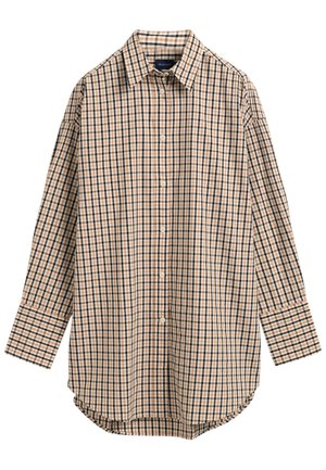 Chemise à manches longues boutonnée à motif à carreaux beige, noir et blanc avec un col pointu.