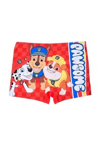 Boys' swim shorts made of red fabric featuring cartoon dogs: a spotted dog, a brown dog in a blue cap, and an orange dog with a yellow cap.