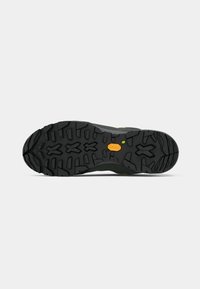 Black rubber outsole with rugged tread pattern; features a textured finish and Vibram logo. Accents include a small yellow and green dot.