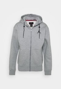 Szara bluza z kapturem zapinana na zamek, wykonana z miękkiego polaru, z kapturem, długimi rękawami, kieszenią z przodu, sznurkiem do regulacji i czarnym logo Jumpman na klatce piersiowej.