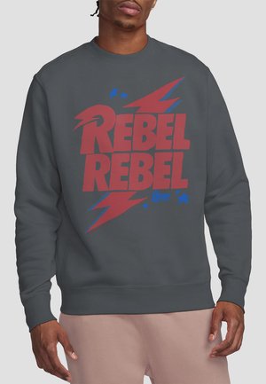 Dark gray sweatshirt with "REBEL REBEL" in bold red and blue graphic, featuring lightning bolt designs and star accents. Soft texture.