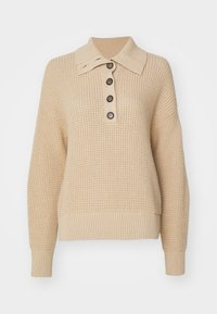 Beige wafelgebreide trui met een brede kraag, vier donkere knopen op de sluiting, lange mouwen en geribde manchetten en zoom.