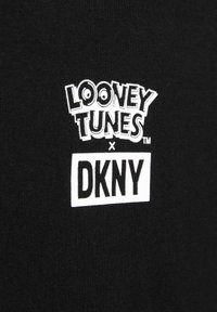 Czarna tkanina z białym graficznym napisem, który brzmi "LOONEY TUNES x DKNY" z stylizowaną czcionką i detalami logo.
