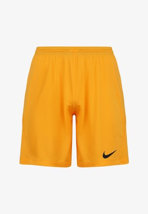 Żółte szorty sportowe wykonane z lekkiego materiału, posiadające elastyczny pas i czarne logo Nike na dolnej lewej stronie.