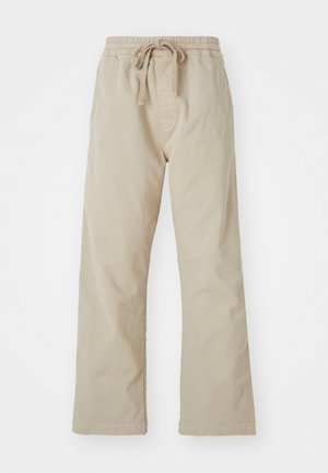 Pantalones de algodón beige con cintura elástica y cordón ajustable. Diseño de pierna recta, textura suave y sin patrones o acentos visibles.