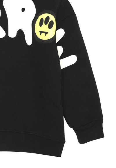 Felpa nera con una mano in stile cartone animato bianca e un cerchio giallo con un design di faccia giocosa; realizzata in tessuto morbido con polsini a coste.