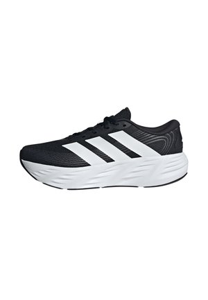 Scarpa da corsa nera con suola bianca e tre ampie strisce bianche sul lato, con intersuola texturizzata e chiusura con lacci.