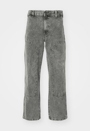 Gray denim pants with a loose fit, featuring two front pockets and knee patches, finished with a straight leg cut and rolled hems.