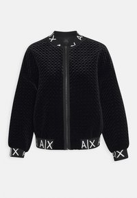 Black bomber jacket made of textured velvet, featuring a zip front, ribbed cuffs, and waistband with logo accents.